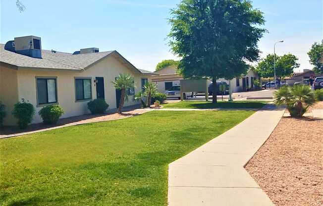 a row of houses in a neighborhood with a green lawn