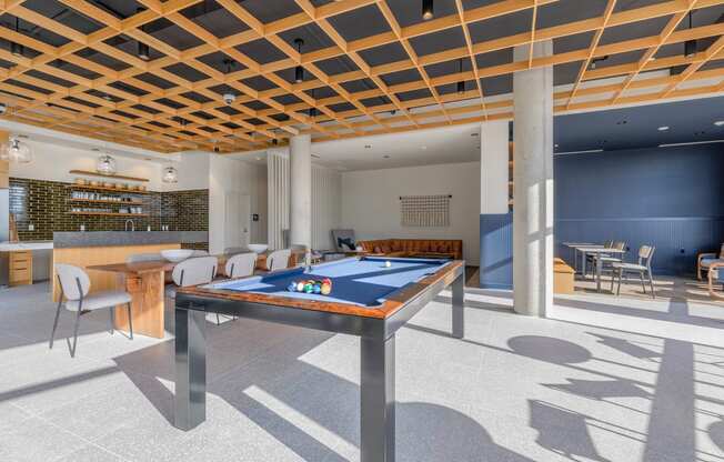 a games room with a pool table and a bar in the background at Marina Square, Bremerton