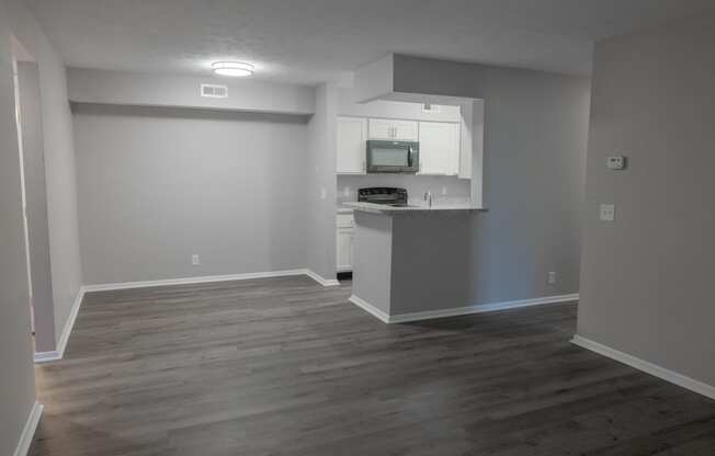 an empty living room and kitchen in a house