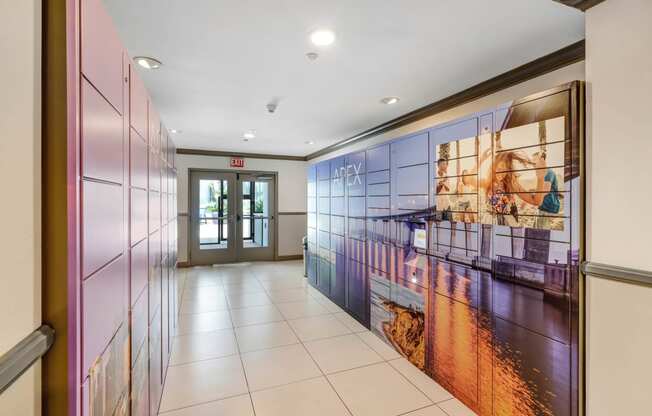 a hallway with a large mural on the wall and a door at the end of the hallway  at Apex Mission Valley, San Diego, California