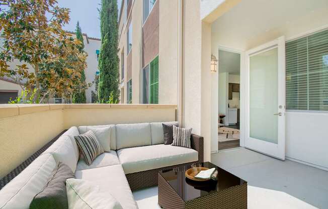 a patio with a couch and a coffee table