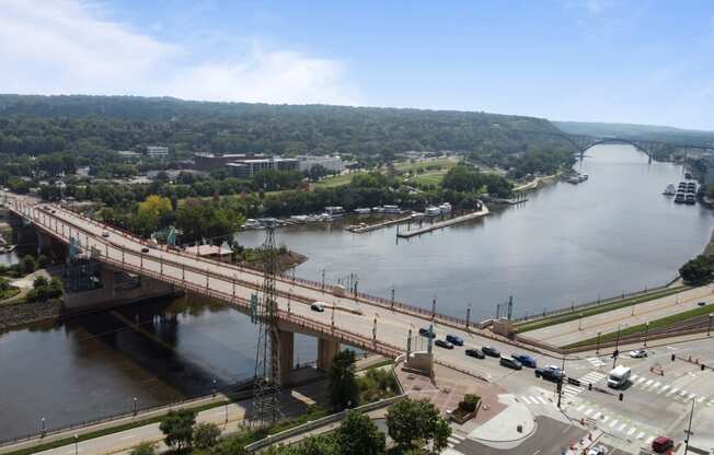 an aerial view of a bridge over a river and a city