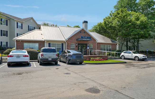 A parking lot with cars and a building with a sign that says "Theatre".