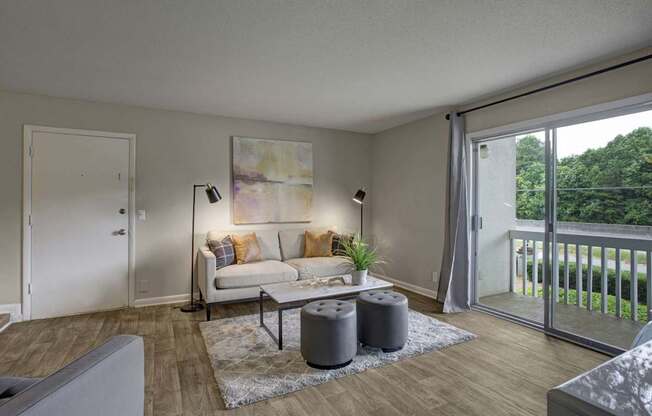 A living room with a couch, a coffee table, and a painting on the wall.