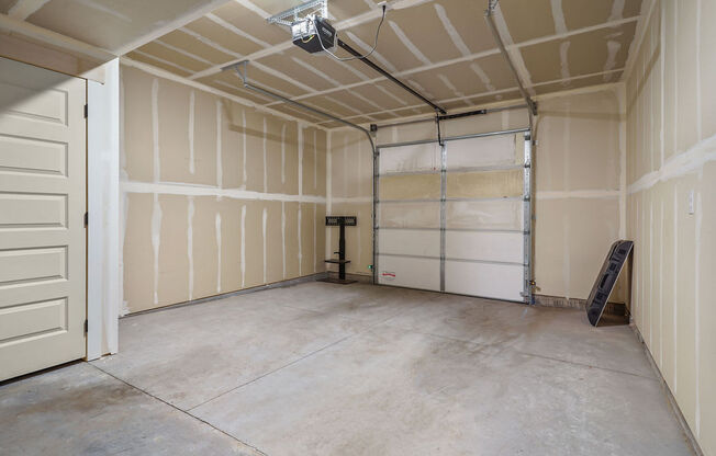 the inside of a garage with white walls and a door