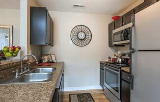 a kitchen with stainless steel appliances and granite counter tops