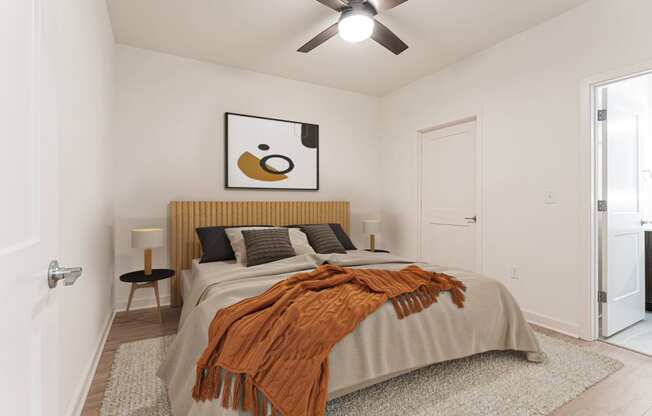 a bedroom with a large bed and a ceiling fan at The Box, Richmond, 23224