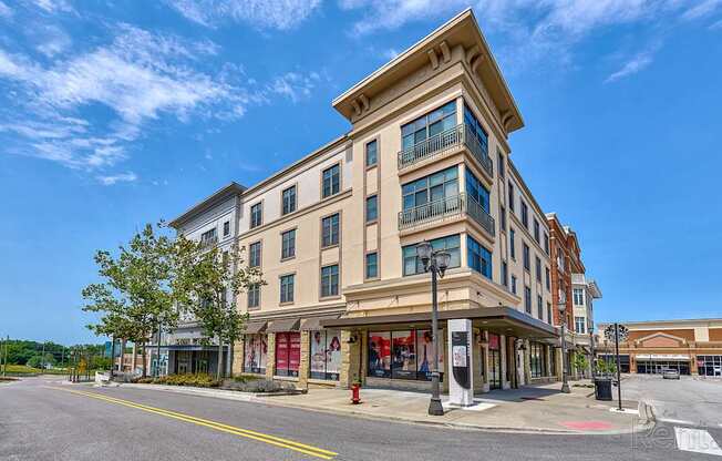 A street view of a multi-story building with a clear blue sky above.