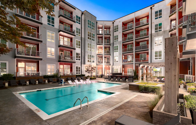 an apartment complex with a swimming pool  at Abberly Noda Vista Apartment Homes, North Carolina