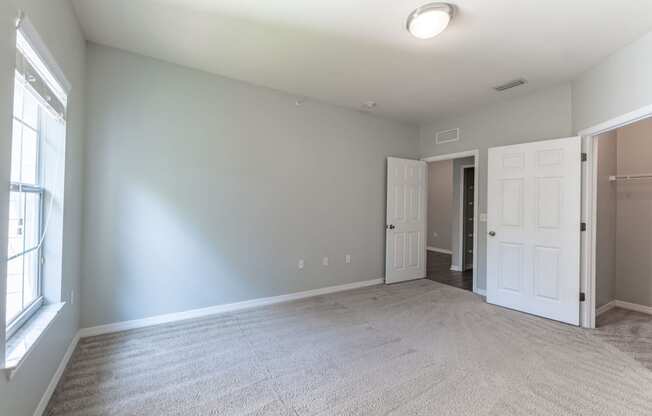 bedroom with carpeted flooring, window, and closet
