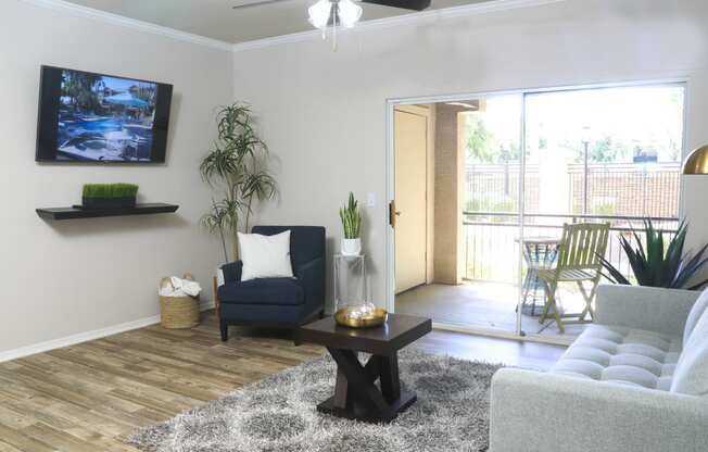 a living room with a couch and a coffee table and a tv