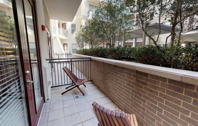 Patio area facing natural landscaping and courtyard area