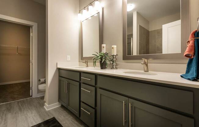 A Bathroom With a Large Mirror at The Aster Apartments, Cary, 27519