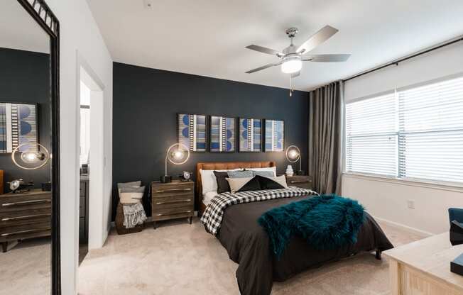 a bedroom with a bed and a ceiling fan