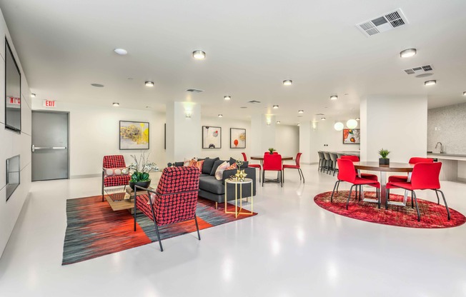 resident lounge with white flooring and red accents and red chairs