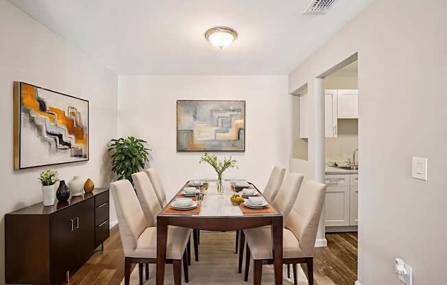 A dining room with a wooden table and chairs.