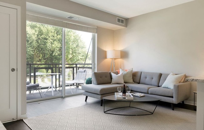 Living Room With Patio/Balcony at The McMillan Apartments in Shorview, MN 55126