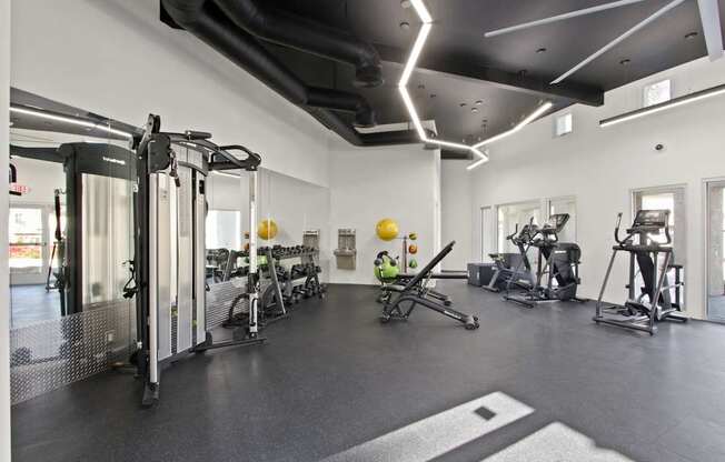 A gym with a variety of exercise equipment.