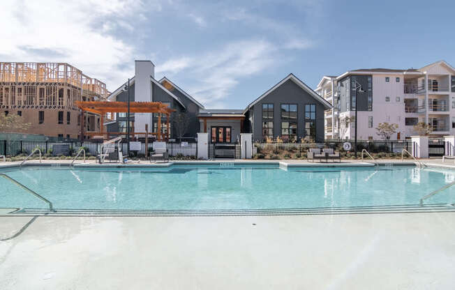 a swimming pool with apartments in the background