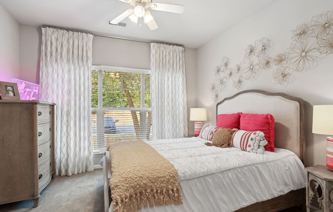 a bedroom with a large bed and a ceiling fan