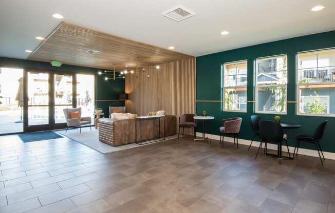 the lobby of a hotel with a reception desk and chairs
