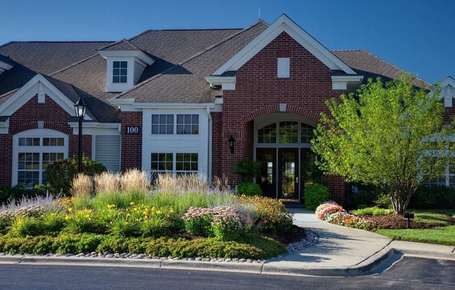 a large house with a driveway and landscaping in front of it