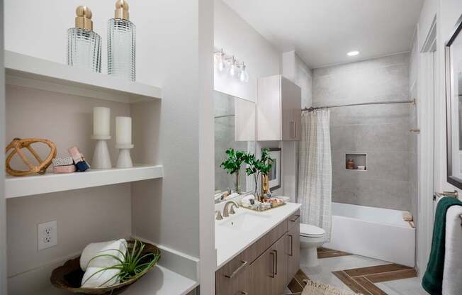 A bathroom with a white counter and a white sink.