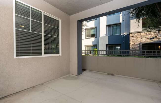 A balcony with a view of a building across the way.