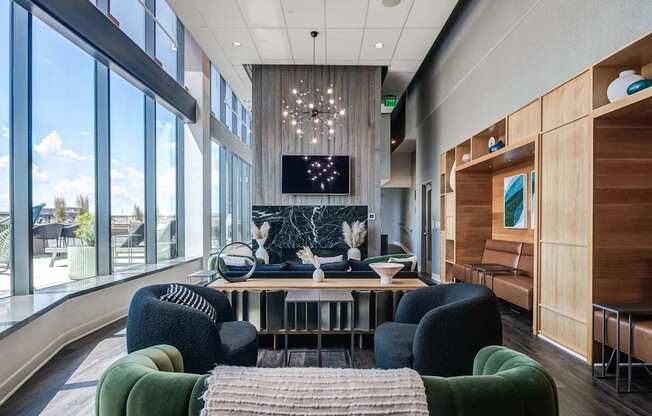 A modern living room with a large window and a TV on the wall.