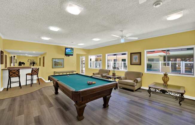 a game room with a pool table    and a bar at Olive Tree Apartments, Torrance, CA