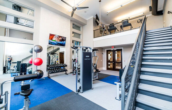 the gym at the ivy hotel is equipped with weights and cardio equipment and stairs