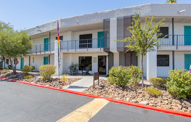 a white building with blue shutters and a yellow line in front of it