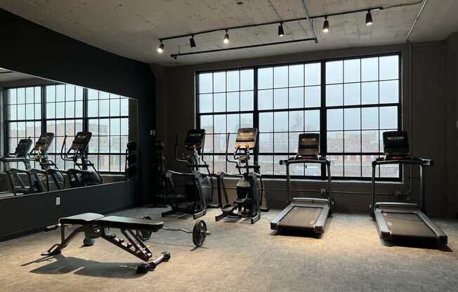 a fitness room with treadmills and other exercise equipment