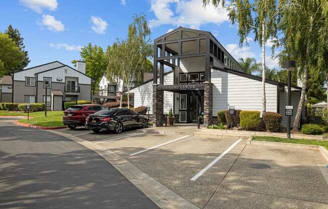 a parking lot with cars in front of a building