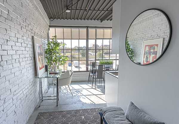 Steelcote Crossing entry way with exposed white brick wall, oversized windows and concrete flooring at Steelcote Square, Missouri, 63103