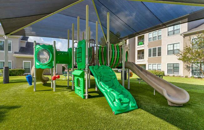 a playground with slides and a tent at Summerwind, Texas