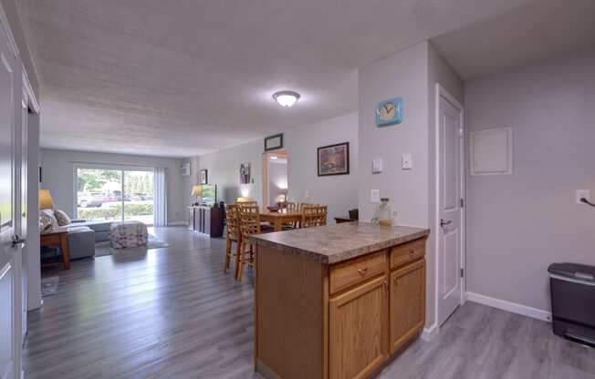 a kitchen with an island and a living room with a dining room