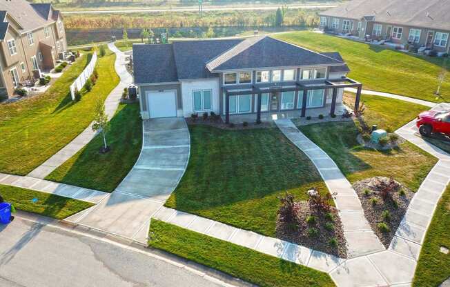 a house in a neighborhood with a walkway and lawn