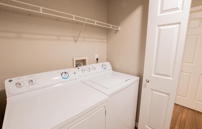 a washer and dryer in a laundry room with a closet