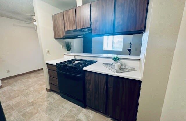 a small kitchen with a stove and cabinets