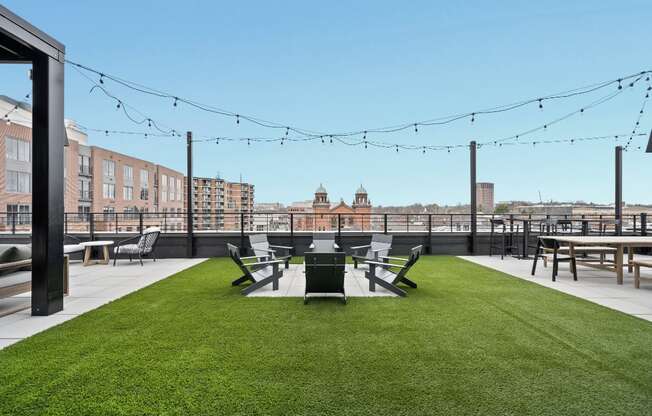 a yard with a table and chairs on top of a roof