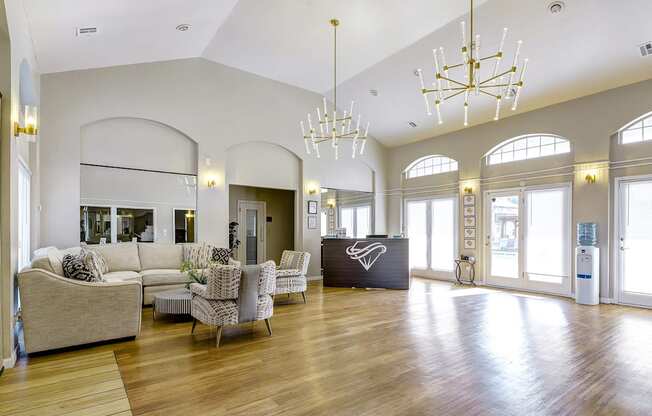 a large living room with couches and chairs and a reception desk