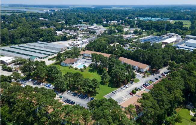 An aerial view of a large building surrounded by trees.
