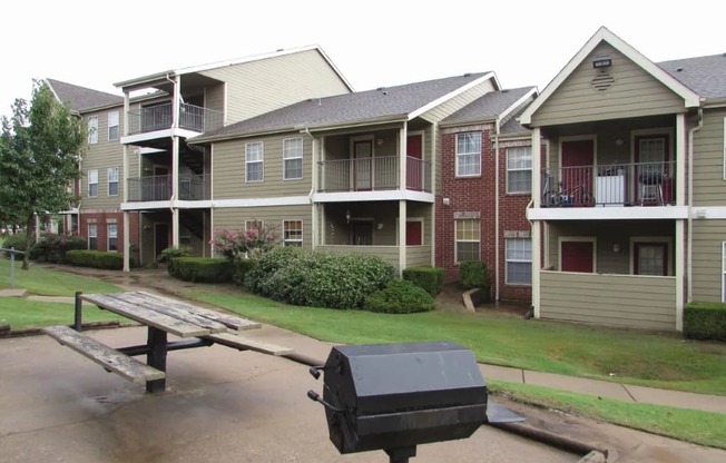 a picnic table in front of an apartment complex at GABLE HILLS Apartments, TULSA