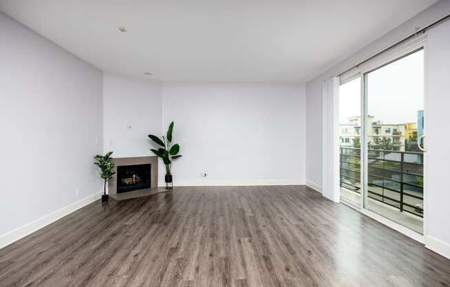 an empty living room with white walls and a fireplace