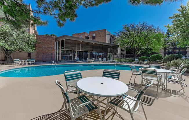 Villa Apartments community pool with tables and chairs