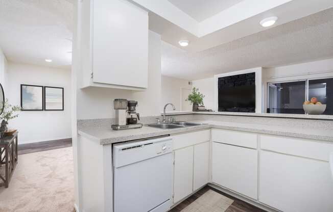 a kitchen with white cabinets and a sink