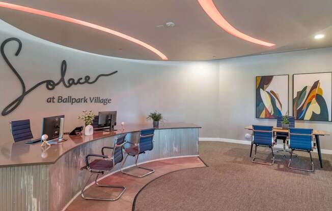 Sobace at Ballpark Village has a modern interior with blue chairs and a reception desk.