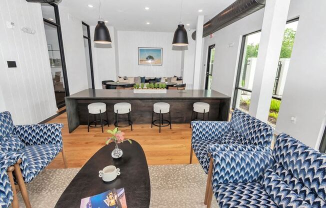 a living room with a table and chairs and a kitchen