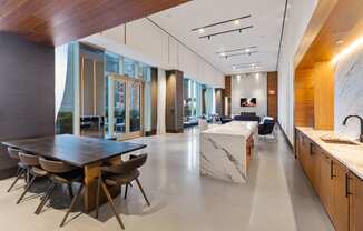 the kitchen and dining area of a large house with a marble table and chairs at The Paxton, Brooklyn, NY
